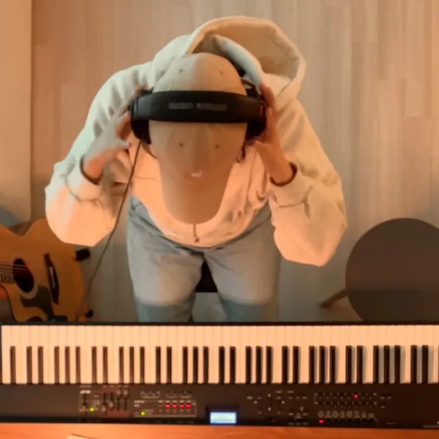 Eunyu at the keyboard, wearing headphones